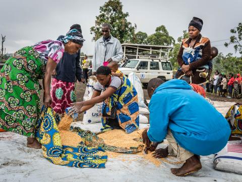 Internal displaced people sharing meal after a food distribution at Kanyaruchinya IDP camp